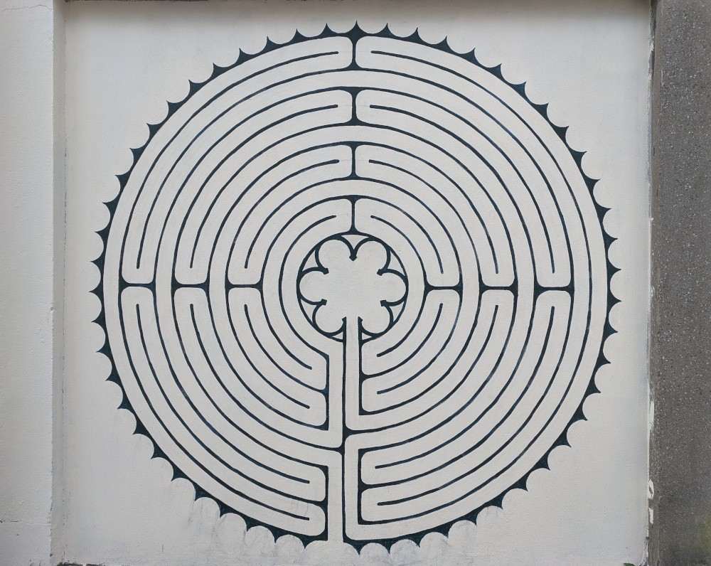 A circular labyrinth painted on a wall